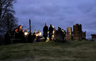 At dawn on March 17, 2025, a group of Christians gather around St. Patrick’s grave in Downpatrick, County Down, in Ireland to pray the Lord’s Prayer 100 times for peace and unity. Credit: Siobhán Brennan