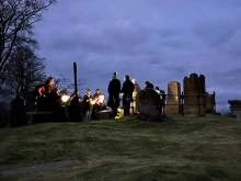 At dawn on March 17, 2025, a group of Christians gather around St. Patrick’s grave in Downpatrick, County Down, in Ireland to pray the Lord’s Prayer 100 times for peace and unity.