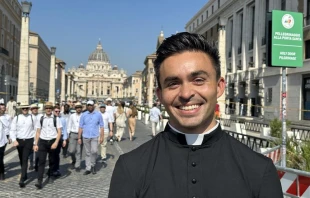 Seminarian Thomas Hammen smiles in view of St. Peter’s Basilica in Rome on Tuesday. June 24, 2025. Credit: Courtney Mares/CNA