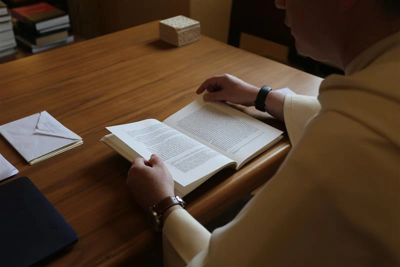 Dominican Father Thomas Joseph White reads the thesis of then-Father Robert Prevost, now Pope Leo XIV, titled “The Role of the Local Prior in the Order of St. Augustine,” which Prevost wrote while a student at Rome’s Pontifical University of St. Thomas Aquinas in the early 1980s.?w=200&h=150