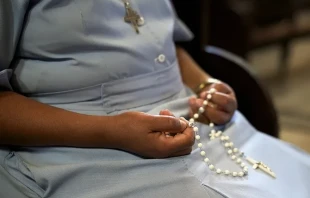 An African nun prays the rosary. On Jan. 7, 2025, two religious sisters were kidnapped in the Archdiocese of Onitsha in Nigeria. Credit: Diego Cervo/Shutterstock