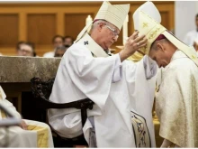 Vancouver Archbishop J.. Michael Miller, left, watches as Edmonton Archbishop Richard Smith places the mitre on Father Gary Franken at his ordination as bishop of St. Paul, Alberta, Canada, in December 2022. Archbishop Smith has been appointed the next archbishop of Vancouver after Pope Francis accepted Archbishop Miller's retirement.
