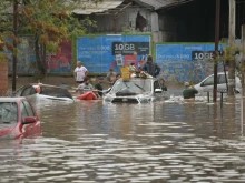People gather on a flooded street after a powerful storm struck the city of Bahia Blanca, 373 miles south of Argentina’s capital, on March 7, 2025.