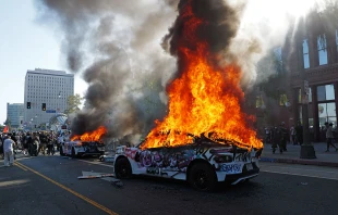 Waymo cars are set on fire and vandalized during a protest against immigration raids on June 8, 2025, in Los Angeles. Credit: Nick Ut/Getty Images