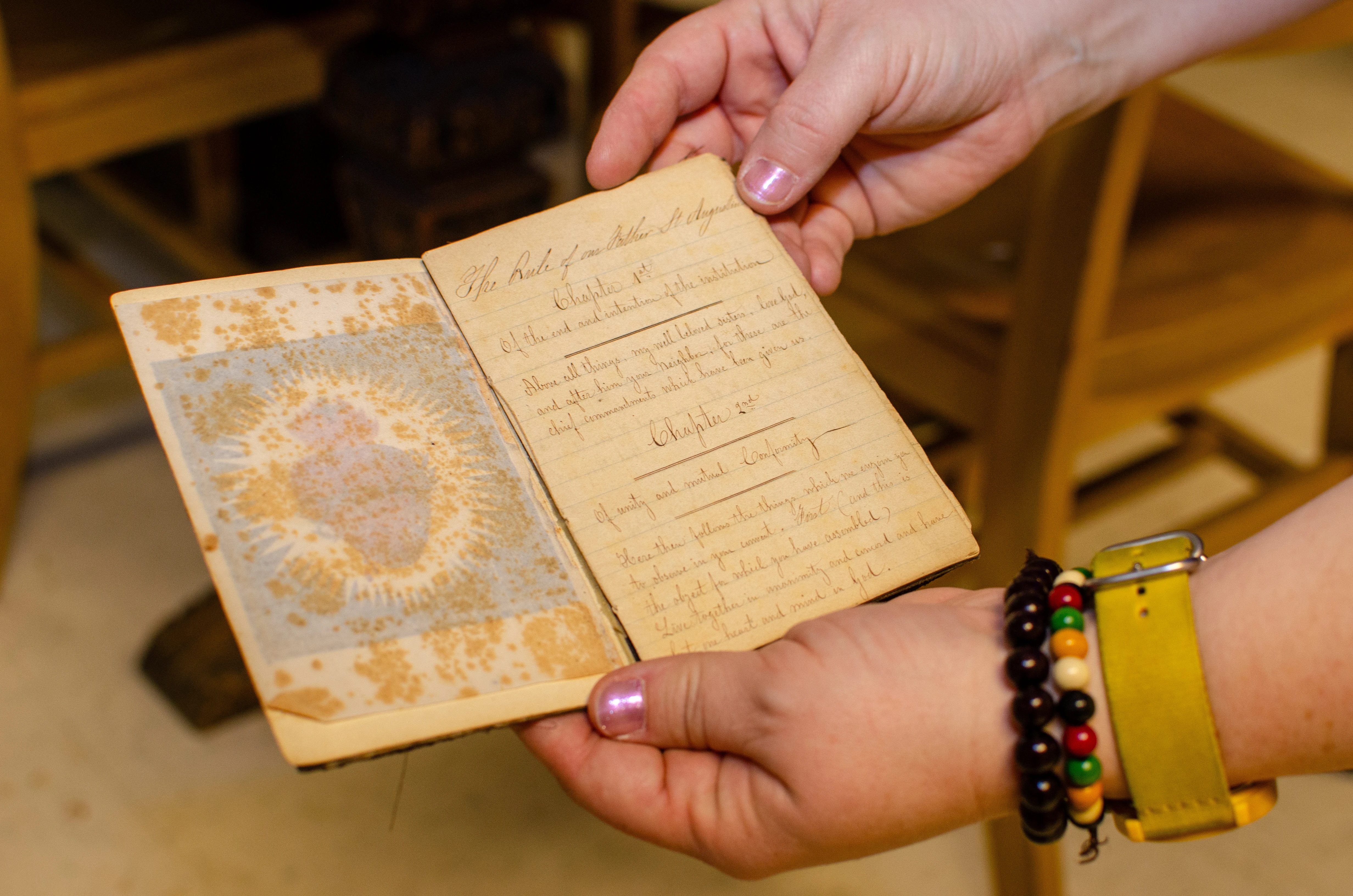 Archivists show a handwritten book of the Rule of St. Augustine found in the Sisters of Charity of St. Augustine’s archives, an example of the materials that will be preserved in WRAC’s future heritage center.?w=200&h=150