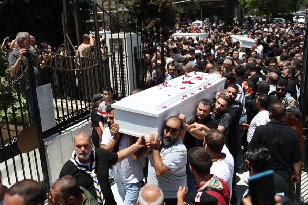 Mourners carry the caskets of the deceased into the Church of the Holy Cross in the Qassaa district of Damascus on Tuesday, June 24, 2025, for the funeral of many of those who lost their lives in a terrorist attack on Mar Elias Church in Damascus two days earlier. Credit: Mohammad Al-Rifai/ACI MENA