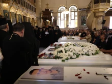 Mourners gather at the Church of the Holy Cross in Qassaa, Damascus, on June 24, 2025, around white caskets of some of the worshippers who lost their lives in a terrorist attack at the Mar Elias Church in the Dweila neighborhood of Syria’s capital on Sunday, June 22, 2025.