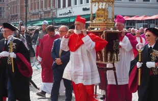 In the morning, the Holy Blood is venerated in St. Salvator Cathedral during a Eucharistic celebration, with archbishop of Tehran Cardinal Dominique Mathieu concelebrating. Then during the procession, he carries the reliquary for part of the route on May 29, 2025. Credit: Thomas P. Reiter