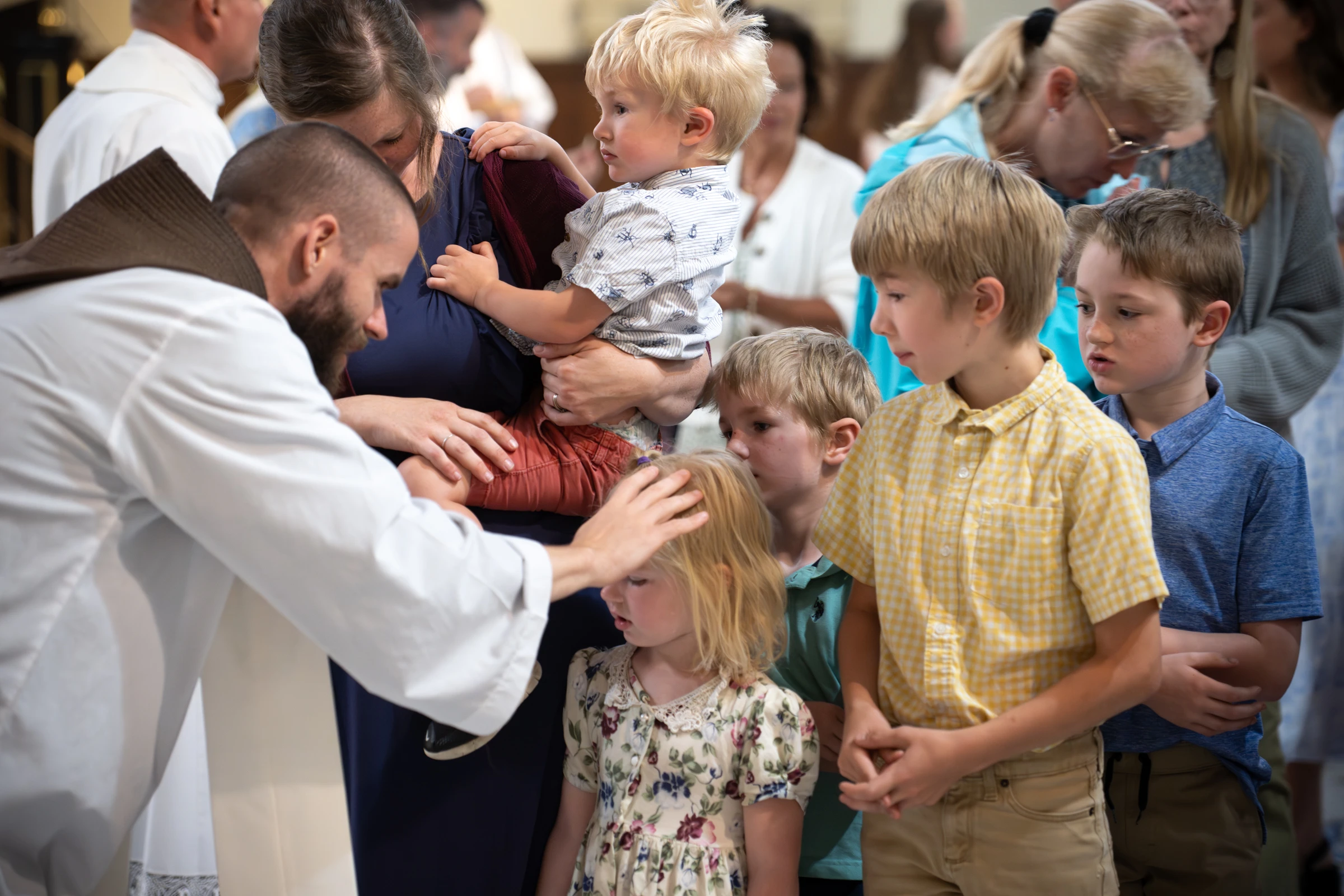 Father Michael Herlihey, OFM Cap, one of three chaplains serving pilgrims along the Drexel Route, blesses children following the opening Mass of the 2025 Eucharistic Pilgrimage in Indianpolis on May 18, 2025.?w=200&h=150