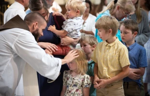 Father Michael Herlihey, OFM Cap, one of three chaplains serving pilgrims along the Drexel Route, blesses children following the opening Mass of the 2025 Eucharistic Pilgrimage in Indianpolis on May 18, 2025. Credit: Jeffrey Bruno