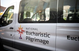 The Blessed Sacrament is seen through the window of the National Eucharistic Pilgrimage van moments before departure from St. John the Evangelist Church in Indianapolis on May 18, 2025. Credit: Jeffrey Bruno