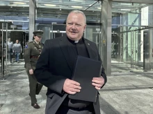 Father Paul Murphy exits the Central Criminal Court in Dublin on Thursday, April 10, 2025, after giving a victim impact statement in a sentencing hearing for a boy who stabbed him.