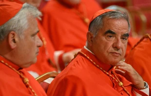 Italian Cardinal Giovanni Angelo Becciu (right) waits prior to the start of a consistory during which 20 new cardinals are to be created by the Pope, on Aug. 27, 2022 at St. Peter's Basilica in the Vatican. ( Photo by ALBERTO PIZZOLI/AFP via Getty Images