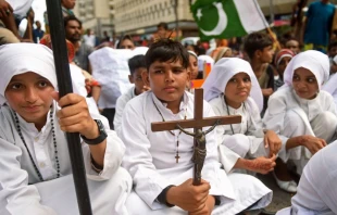 A Christian boy holds a crucifix during a protest in Karachi on Aug. 22, 2023, to condemn the attack on churches in Pakistan. More than 80 Christian homes and 19 churches were vandalized in an hourslong riot in Jaranwala in Punjab province on Aug. 16 after unverified reports that a Koran had been desecrated. Credit: RIZWAN TABASSUM/AFP via Getty Images