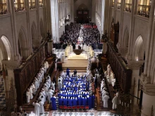 The choir, clergy and guests stand during the ceremony to mark the reopening of Notre-Dame of Paris Cathedral on Dec. 7, 2024, in Paris.