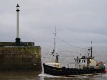 A fishing boat returns to Bridlington Harbor after a day at sea on Jan. 31, 2025, in Bridlington, England. Bridlington is the leading shellfish port in Europe.