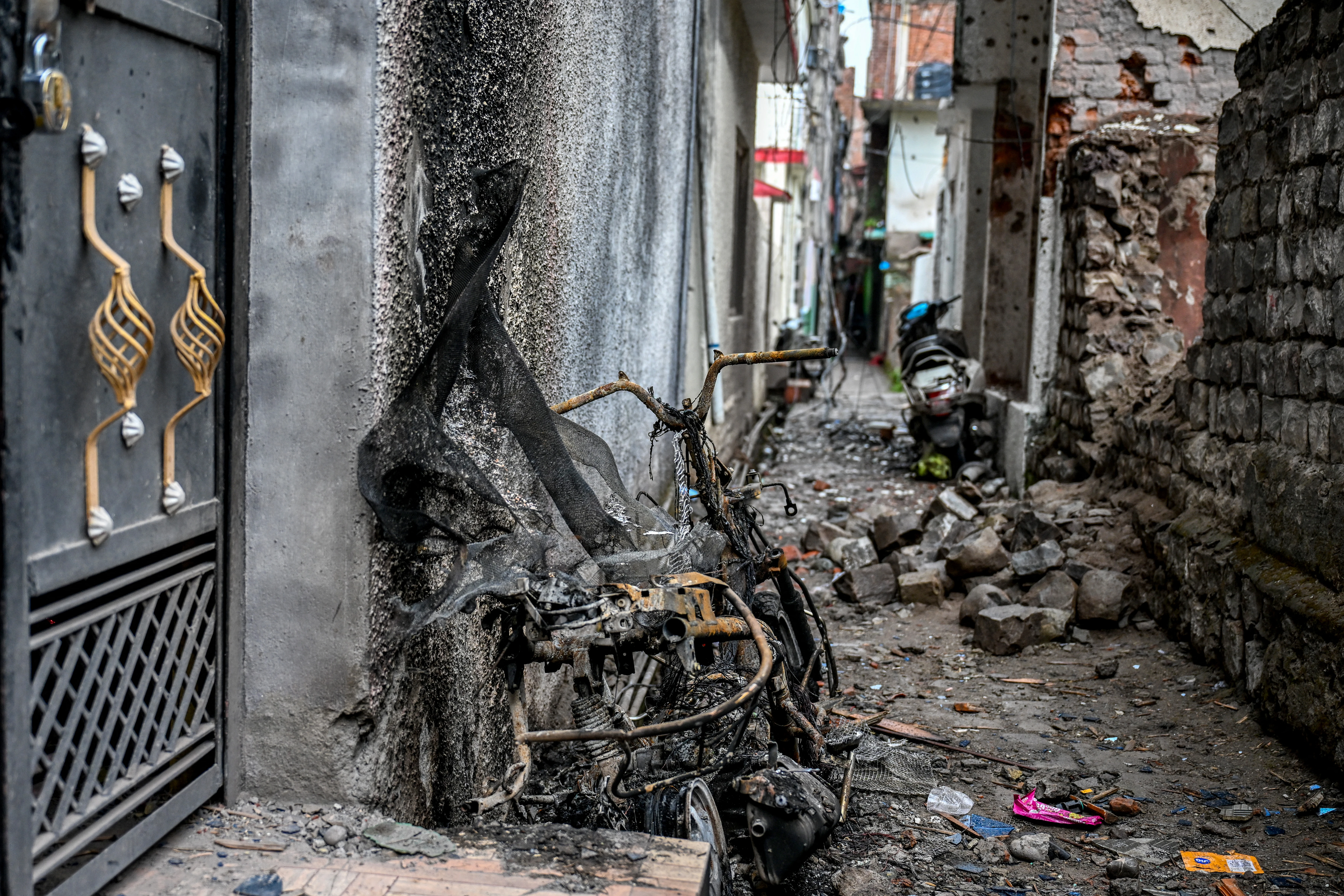 A burnt scooter on May 9, 2025, stands on the spot where twins Zian Khan and Urwa Fatima died on May 7 during Pakistani artillery shelling in the main town of Poonch district.?w=200&h=150