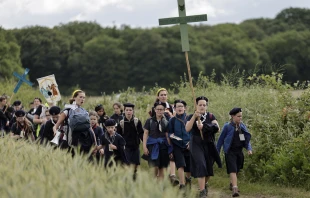 Young people hold crosses as they arrive for Mass during the traditional Pentecostal pilgrimage from Paris to Chartres, in Sonchamp, near Paris, on June 8, 2025. Credit: STEPHANE DE SAKUTIN/AFP via Getty Images