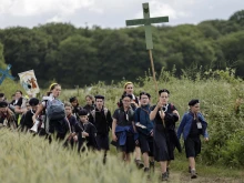 Young people hold crosses as they arrive for Mass during the traditional Pentecostal pilgrimage from Paris to Chartres, in Sonchamp, near Paris, on June 8, 2025.