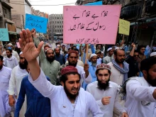 Supporters of a religious group march during a rally in support of Khalid Khan, who killed a man accused of blasphemy, in Peshawar on July 31, 2020.