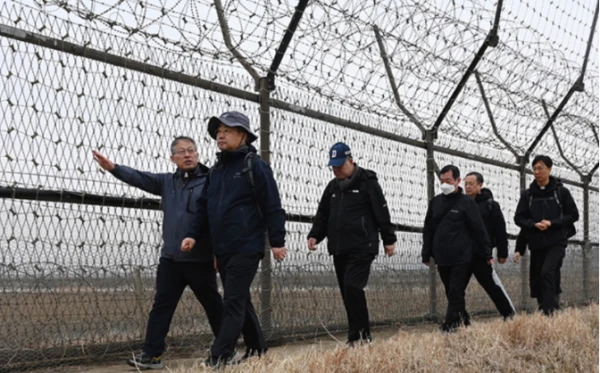 South Korean bishops walking alongside the barbed wire fence that has divided the two countries since the Korean War in 1953. Credit: Courtesy of South Korean Bishops' Conference
