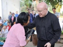 At a leper colony in the Kon Tum area in Vietnam, Pontifical Missions Society USA President Monsignor Roger Landry celebrated Mass, brought Communion to people, and distributed food and sandals.