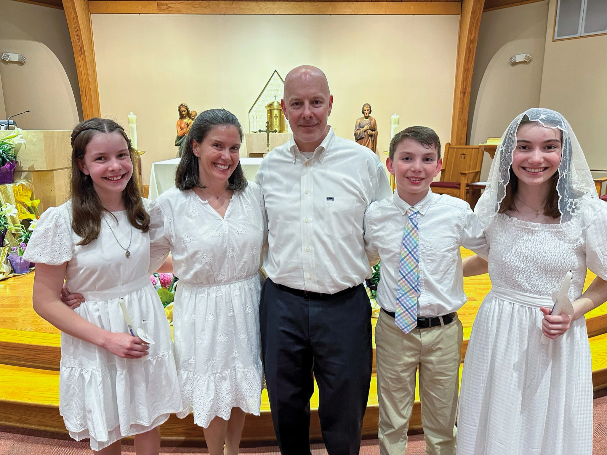 The McCoppin family (from left): Alyssa, Courteney, James, Rhys, and Kelly, poses for a photo after entering the Catholic Church at the Easter Vigil on April 8, 2023, at Sacred Heart Church in Manassas.?w=200&h=150