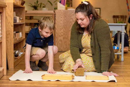 Cassandra Baker, now a coordinator for the Catholic Montessori Institute, presents a math lesson introducing the decimal system to a 4-year-old student in spring 2023 at the Christ the King Catholic Montessori Grade School in Mandan, North Dakota.?w=200&h=150