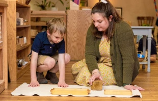 Cassandra Baker, now a coordinator for the Catholic Montessori Institute, presents a math lesson introducing the decimal system to a 4-year-old student in spring 2023 at the Christ the King Catholic Montessori Grade School in Mandan, North Dakota. Credit: Mike McCleary/University of Mary