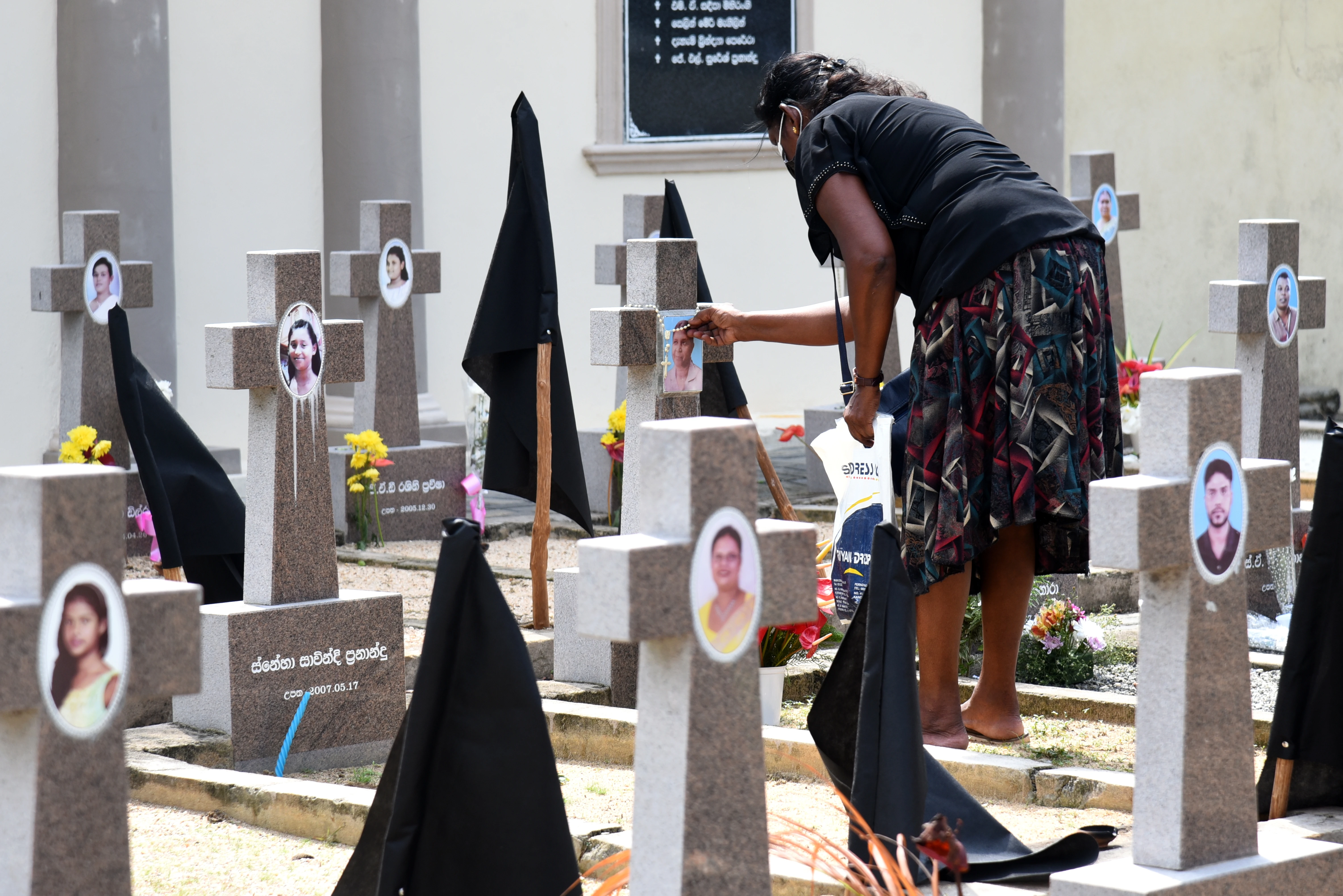 A woman pays tribute to victims of the 2019 Easter Sunday terror attacks at a cemetery in Negombo, Sri Lanka, on April 21, 2022, marking three years since the tragic attacks.?w=200&h=150