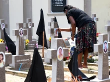 A woman pays tribute to victims of the 2019 Easter Sunday terror attacks at a cemetery in Negombo, Sri Lanka, on April 21, 2022, marking three years since the tragic attacks.