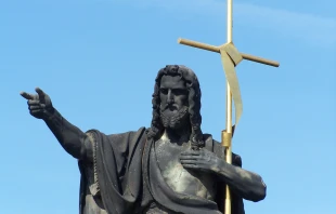Statue of St. John the Baptist with golden cross, Charles Bridge, Prague, Czech Republic. Credit: Oldrich Barak/Shutterstock