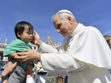 Pope Leo XIV blesses a small attendee at the general audience in St. Peter’s Square on Wednesday, June 4. 2025.